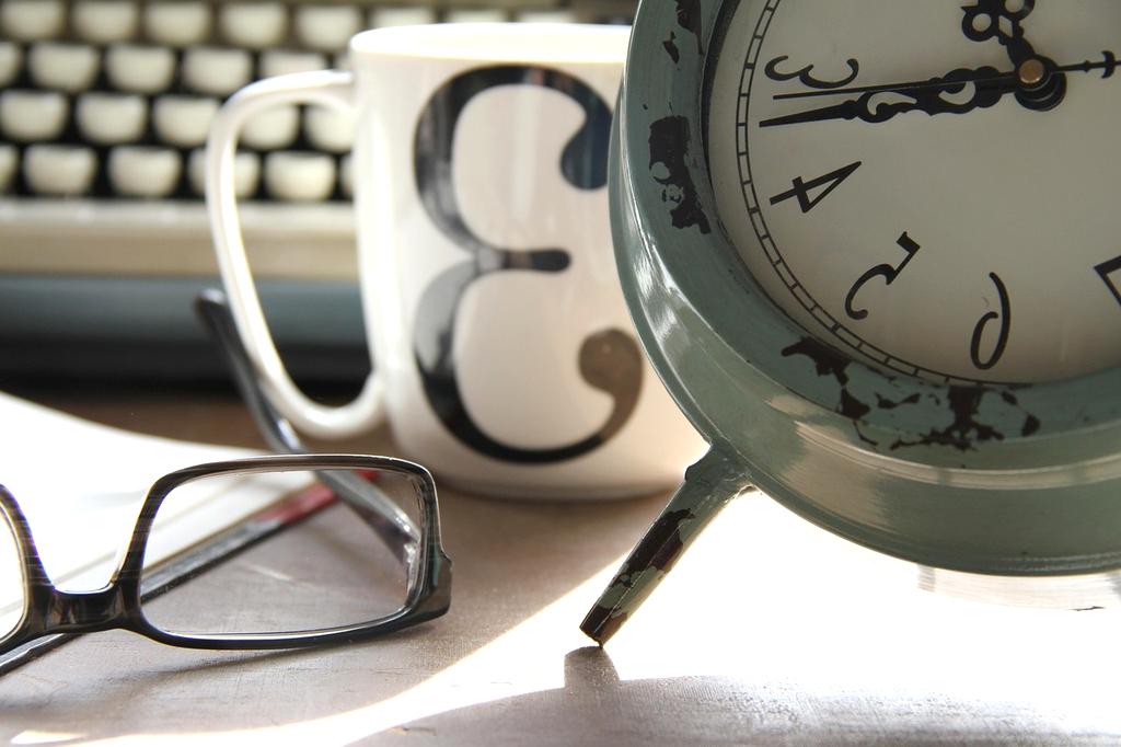 Open book with notes and laptop on a modern working desk